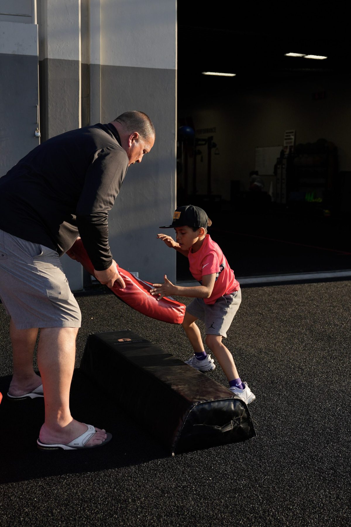 Young athlete being coached through a drill